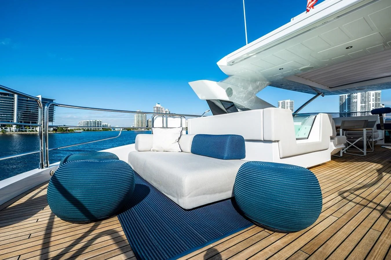 a deck with a large white boat on it and a large round black object on the deck with aboard ROMANI Yacht for Sale