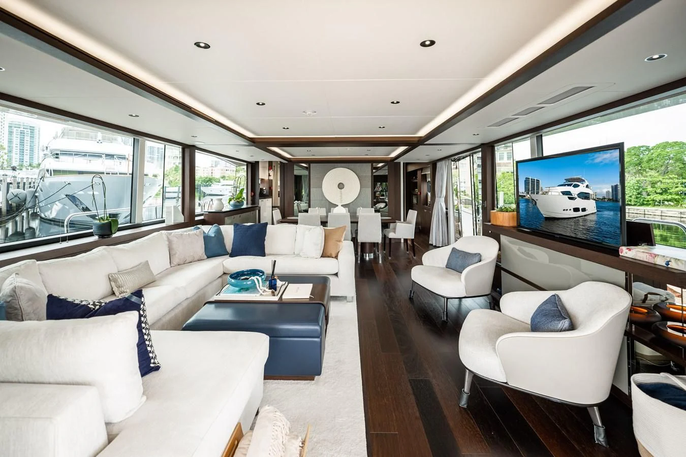 a living room with a large screen aboard ROMANI Yacht for Sale