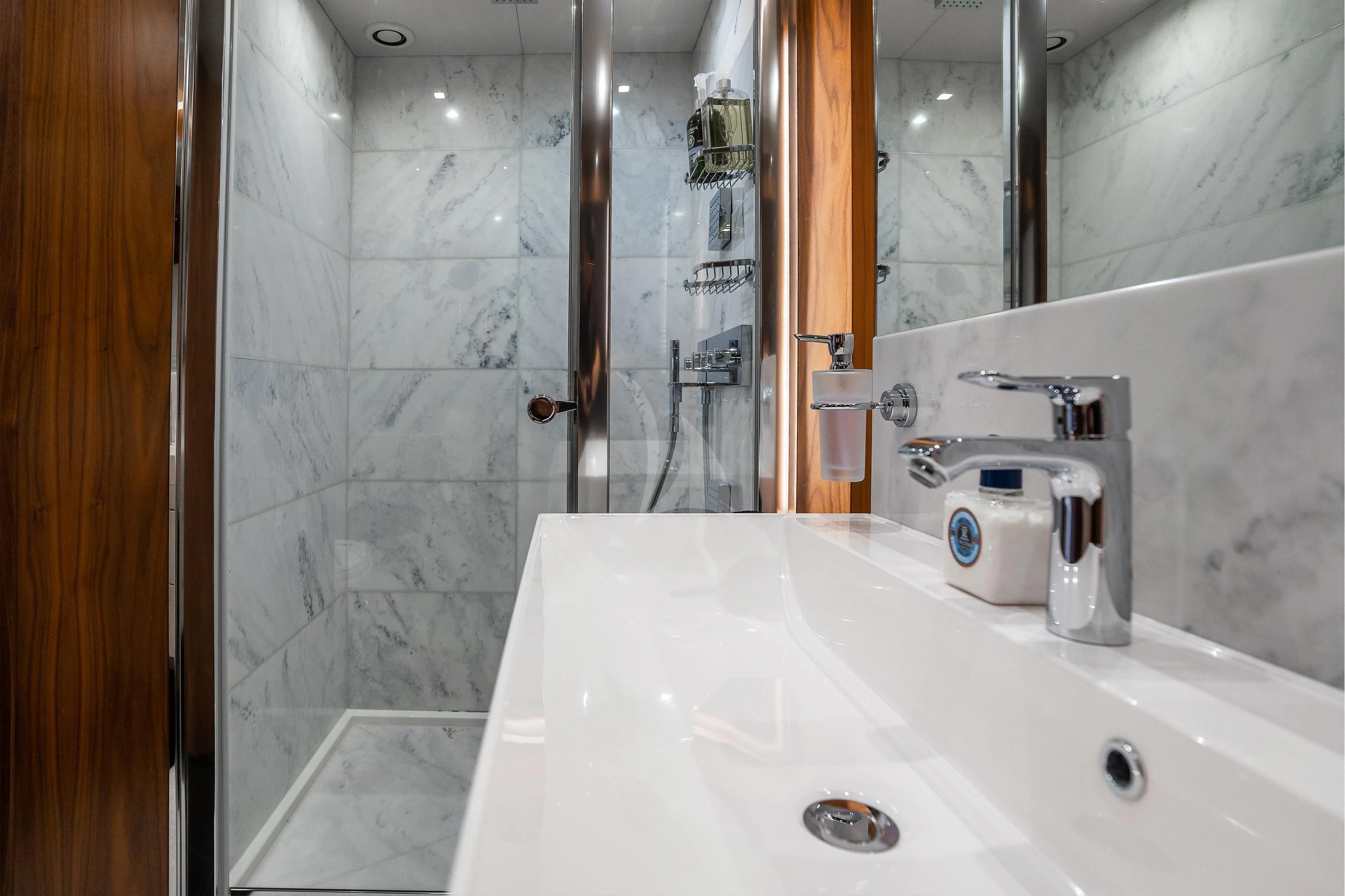 a bathroom with a glass shower aboard ELITE Yacht for Sale