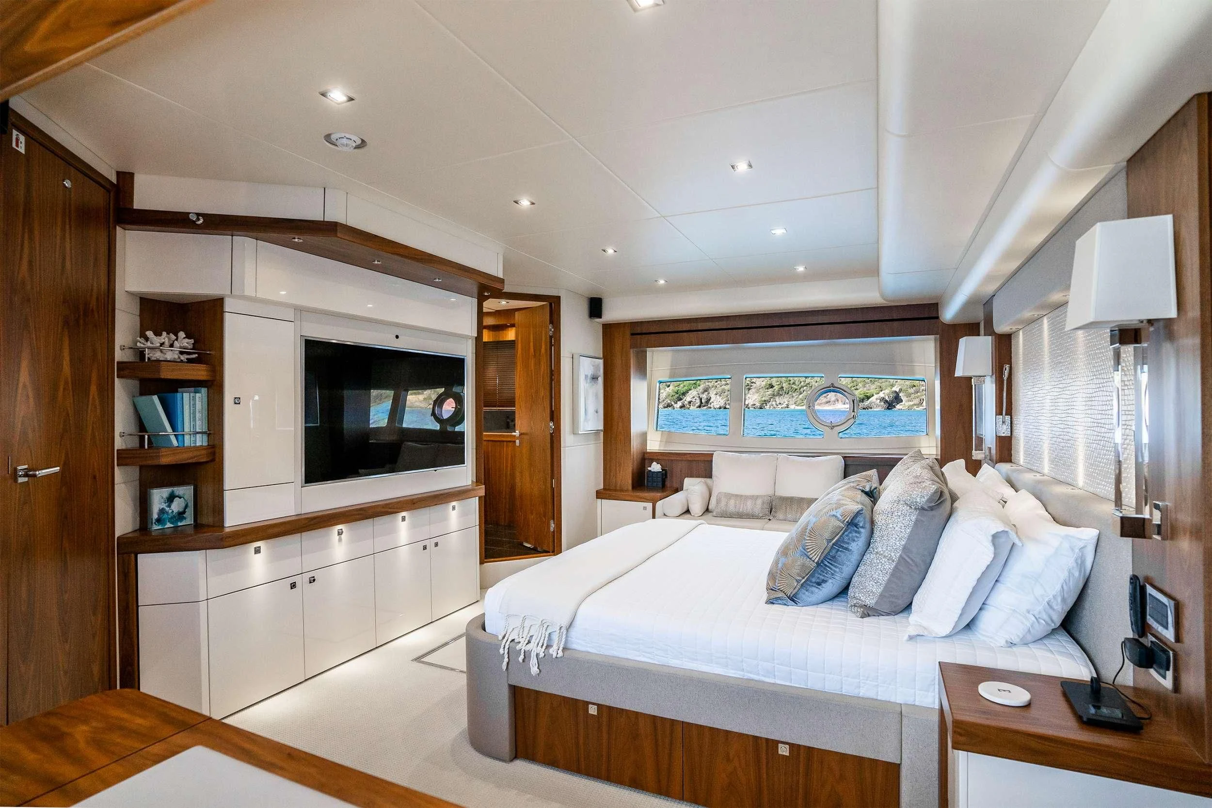 a bedroom with a bed and a desk aboard ELITE Yacht for Sale