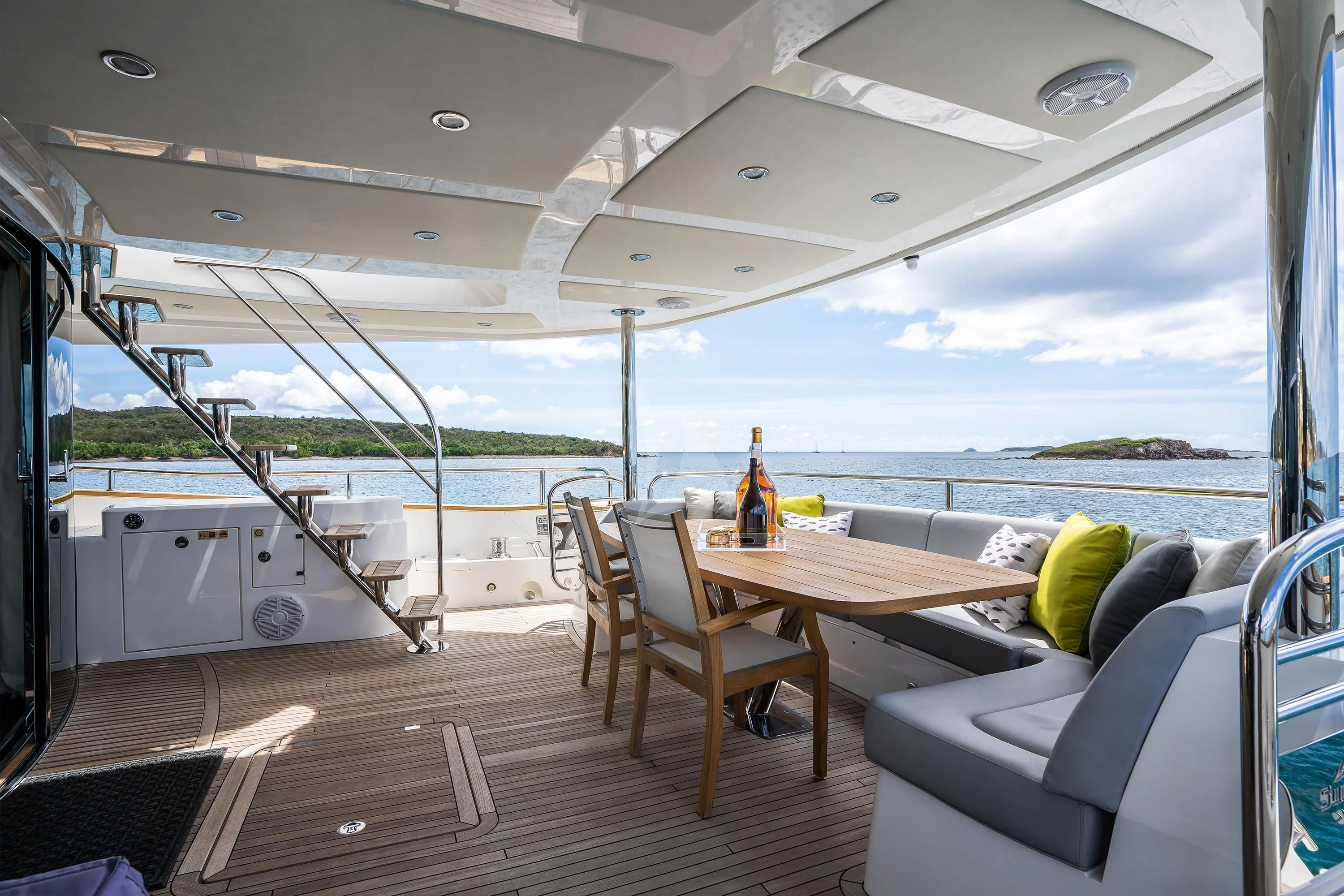 a deck with a table and chairs aboard ELITE Yacht for Sale