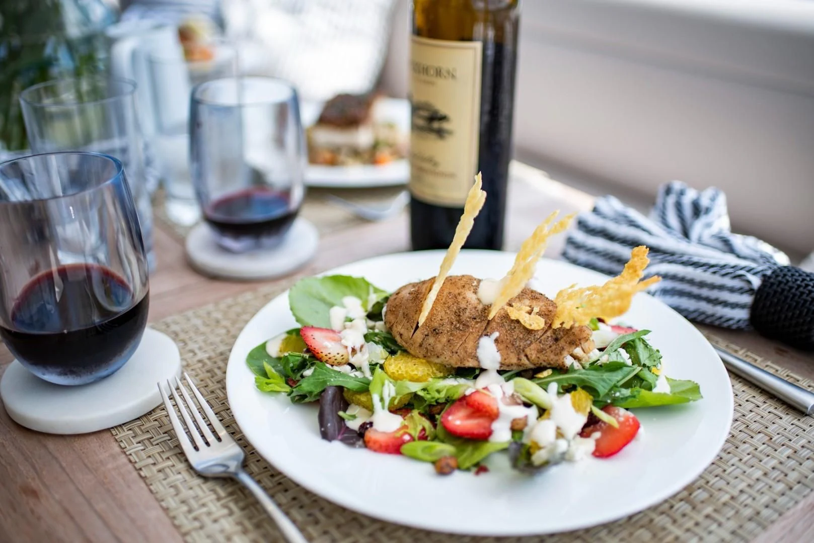 a plate of food and a glass of wine aboard ELITE Yacht for Sale