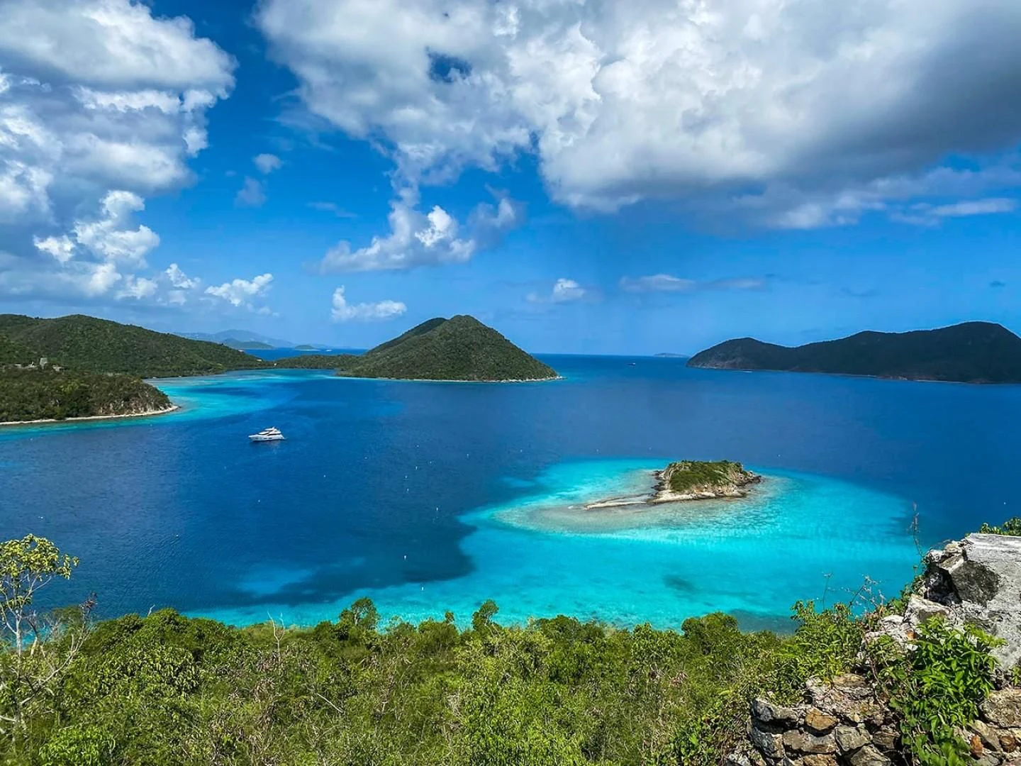 a body of water with islands in the distance with Virgin Islands National Park in the background aboard ELITE Yacht for Sale