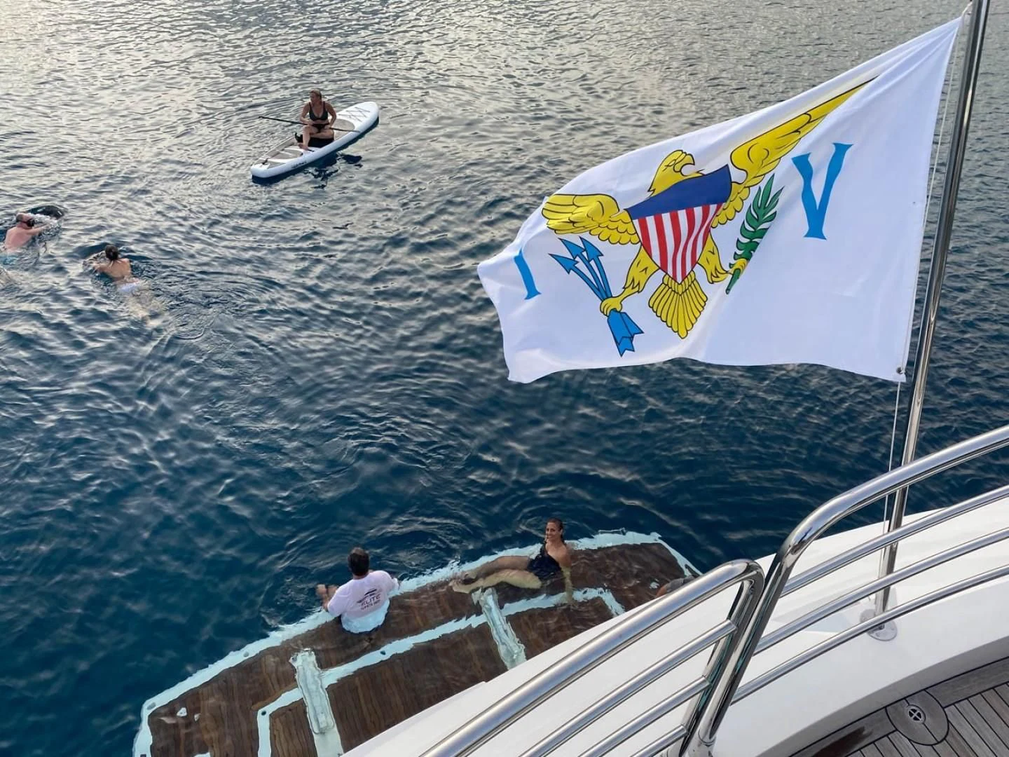a sailboat with a flag aboard ELITE Yacht for Sale