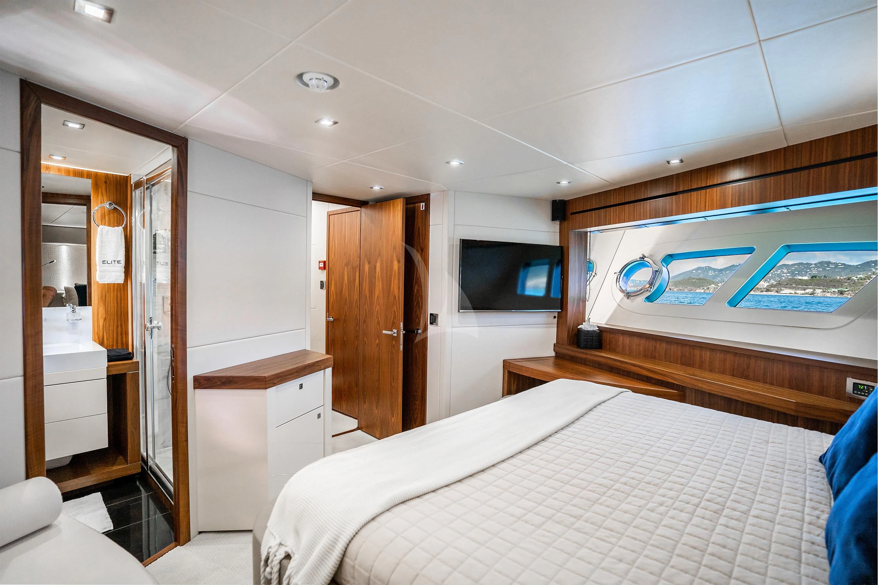 a room with a bed and a television aboard ELITE Yacht for Sale