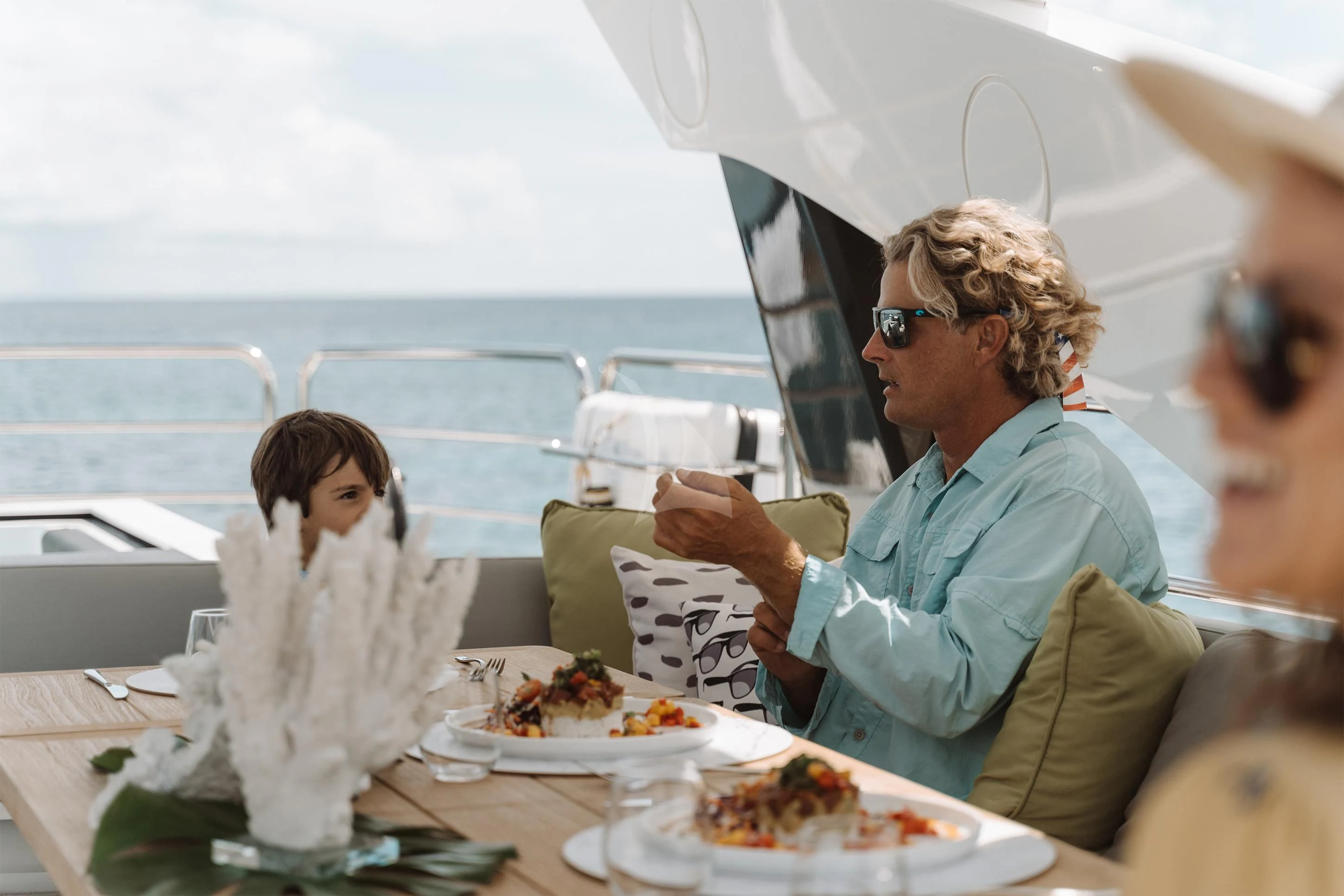 a woman and a man eating food aboard ELITE Yacht for Sale