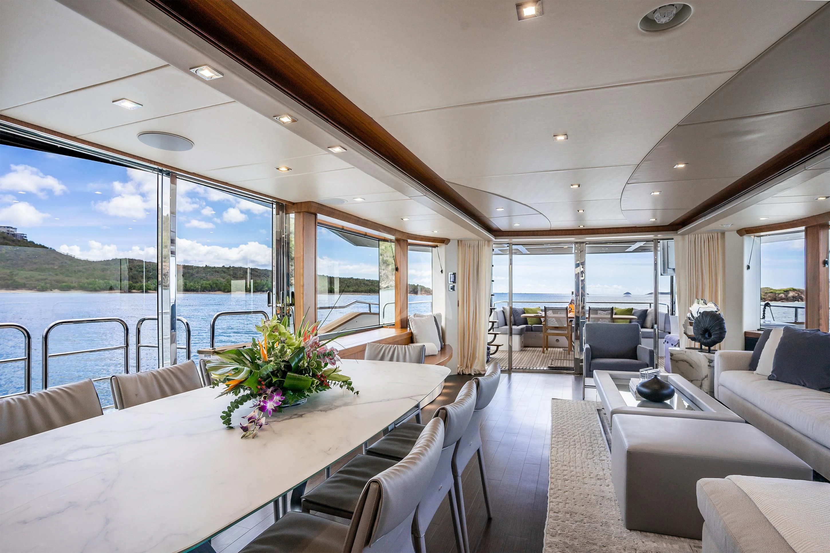 a large room with a large window and a table with chairs aboard ELITE Yacht for Sale