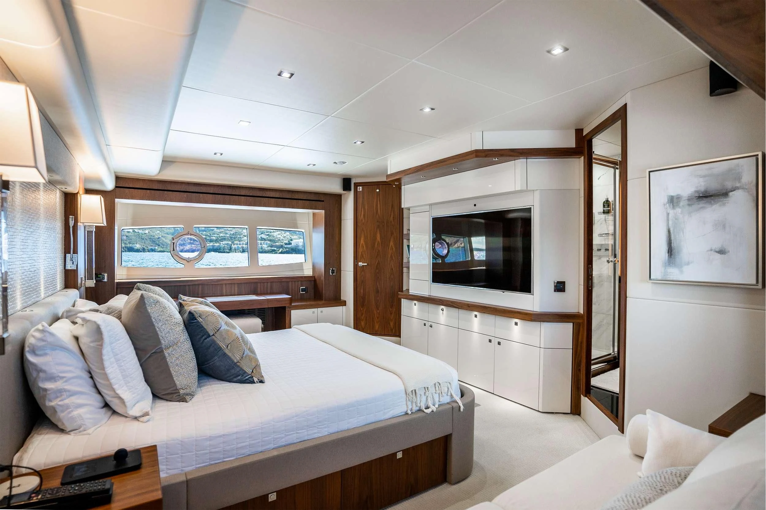 a bedroom with a bed and a television aboard ELITE Yacht for Sale