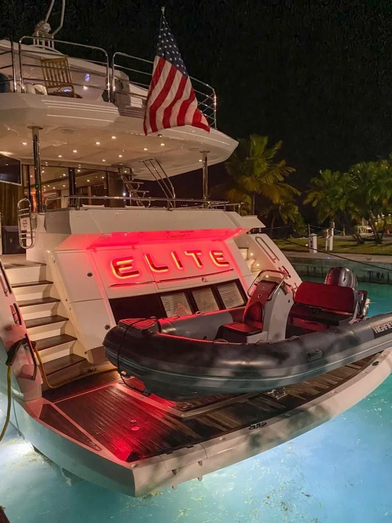 a boat with a flag on it aboard ELITE Yacht for Sale