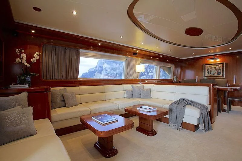 a living room with a couch and a table aboard SOHO Yacht for Sale