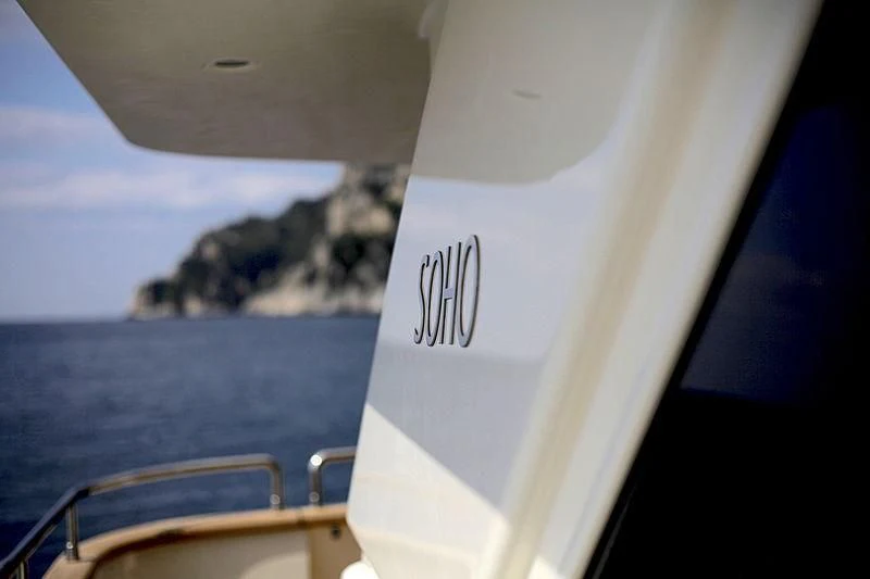 a boat with a white sail aboard SOHO Yacht for Sale