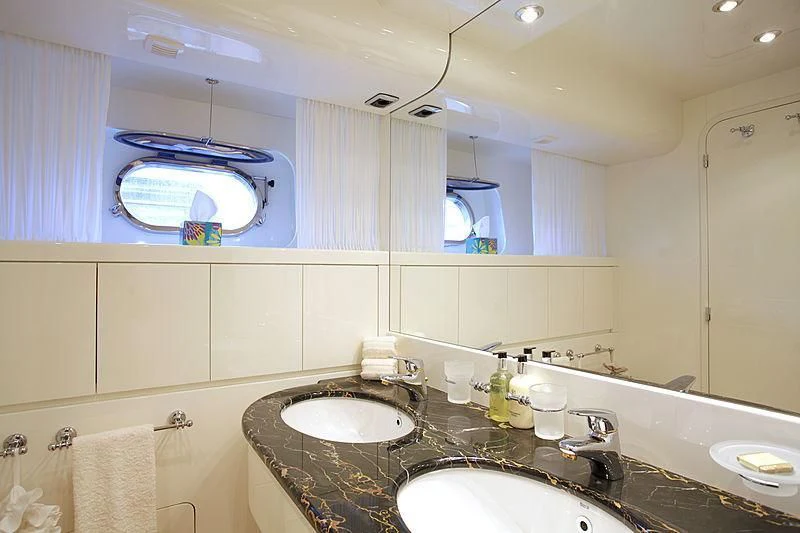 a bathroom with a large mirror aboard SOHO Yacht for Sale