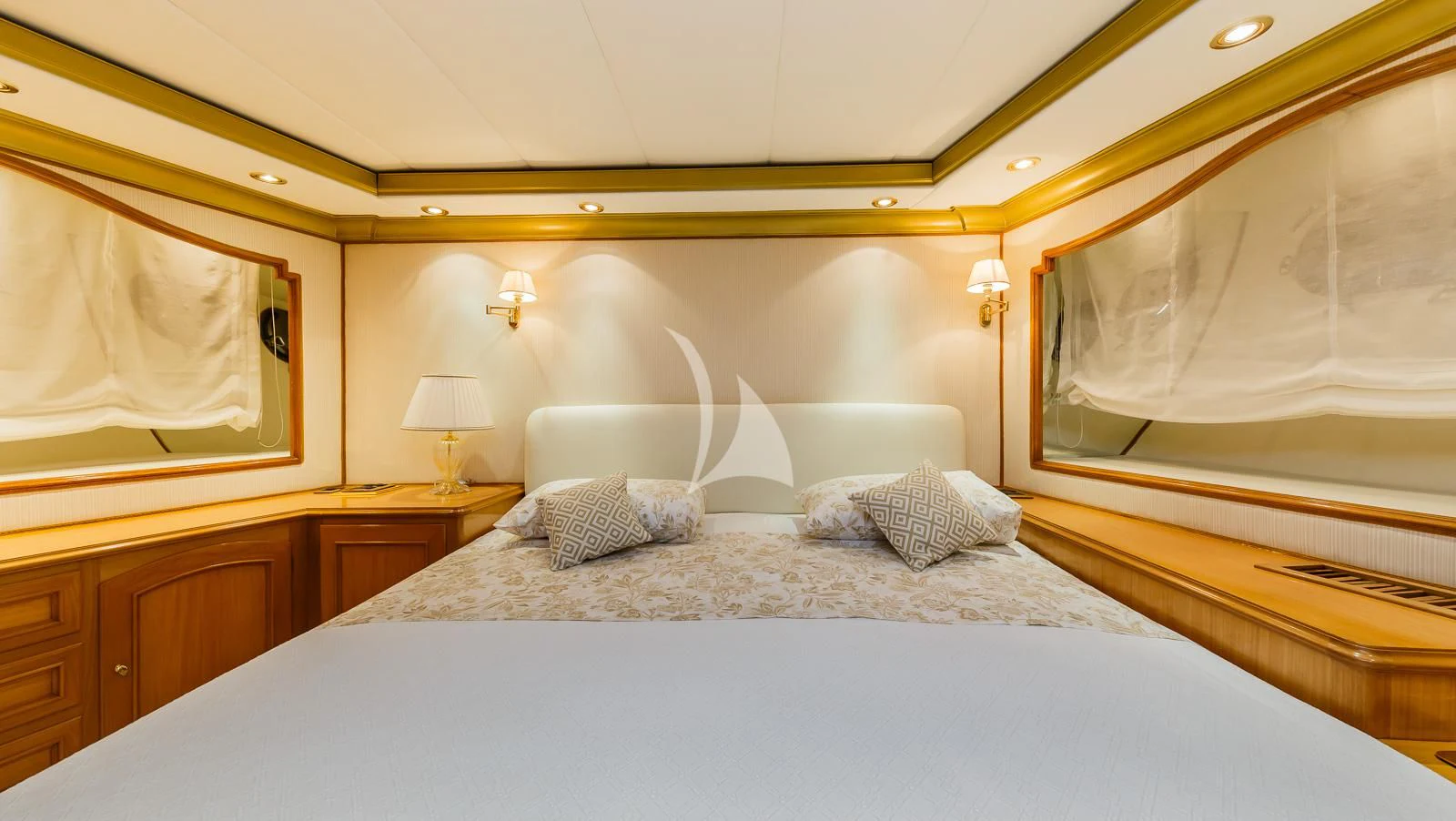 a bed with a white sheet and pillows aboard TO JE TO Yacht for Sale