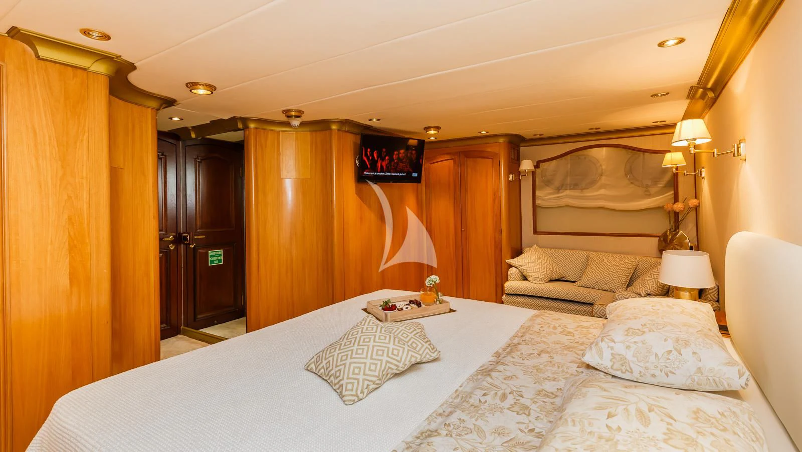 a hotel room with a bed and a couple of lamps aboard TO JE TO Yacht for Sale