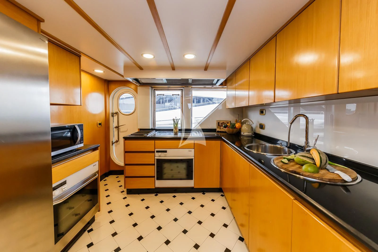 a kitchen with a stove and sink aboard TO JE TO Yacht for Sale
