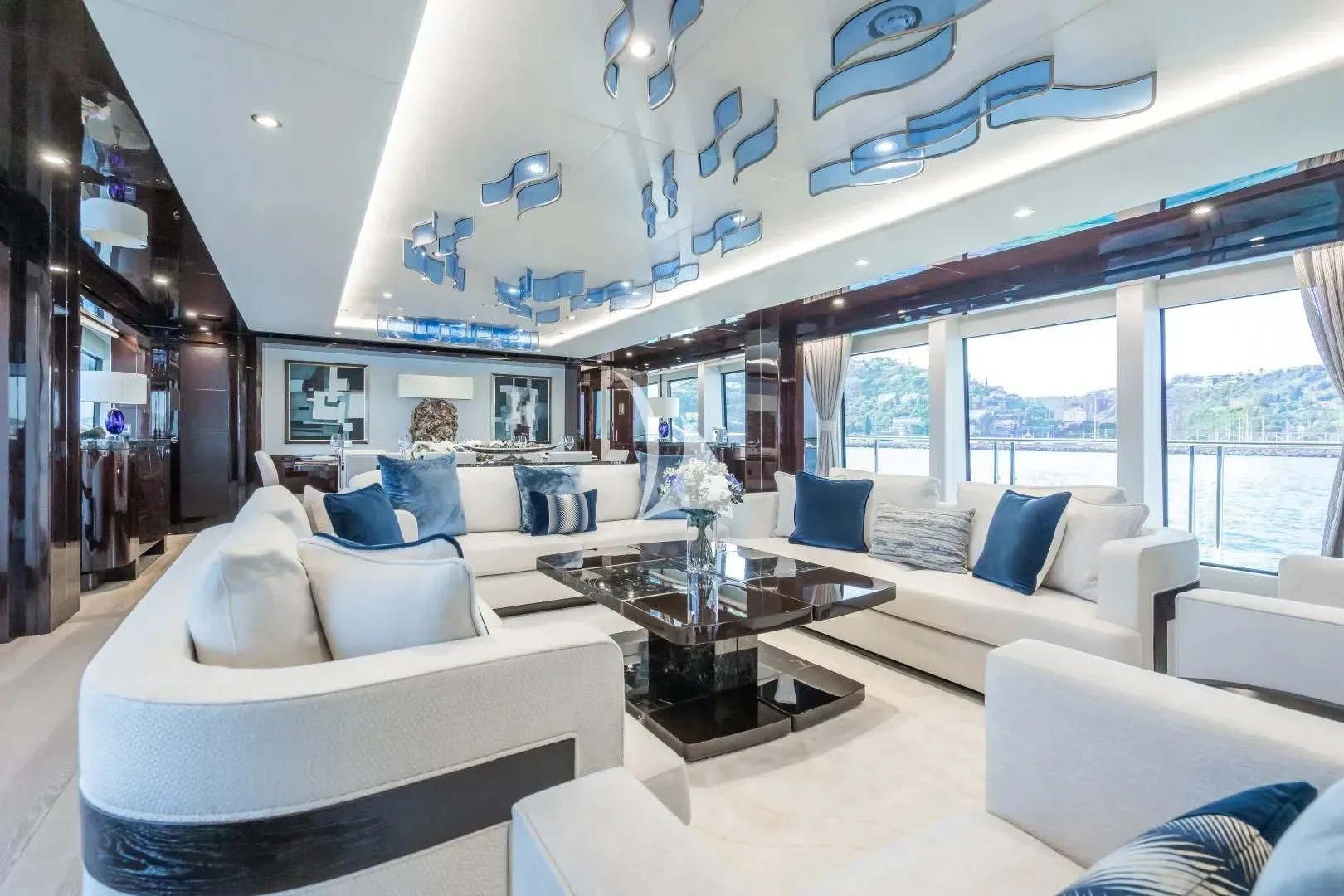 a living room with white couches aboard NO.9 Yacht for Sale