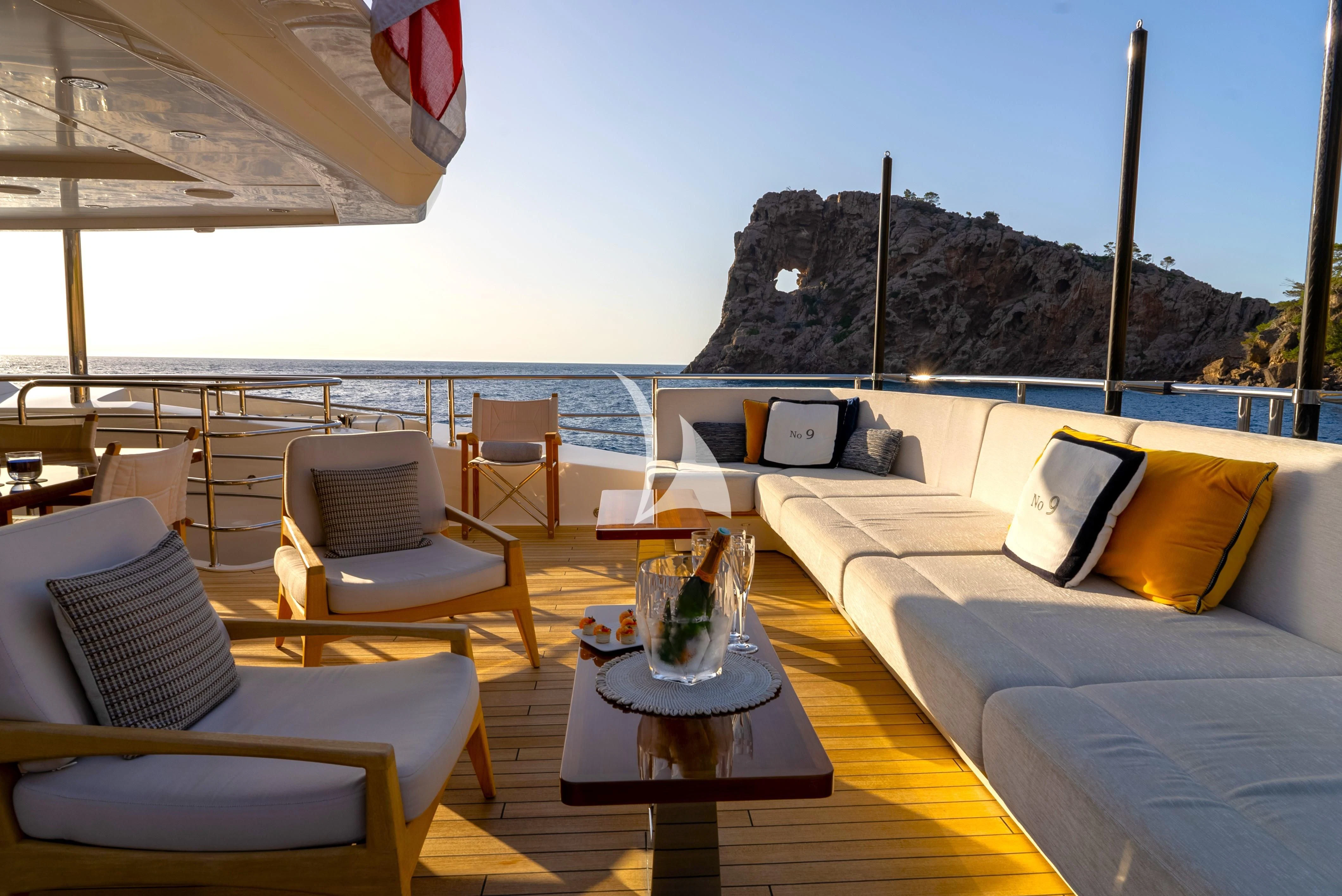 a room with a table chairs and a view of the mountains aboard NO.9 Yacht for Sale