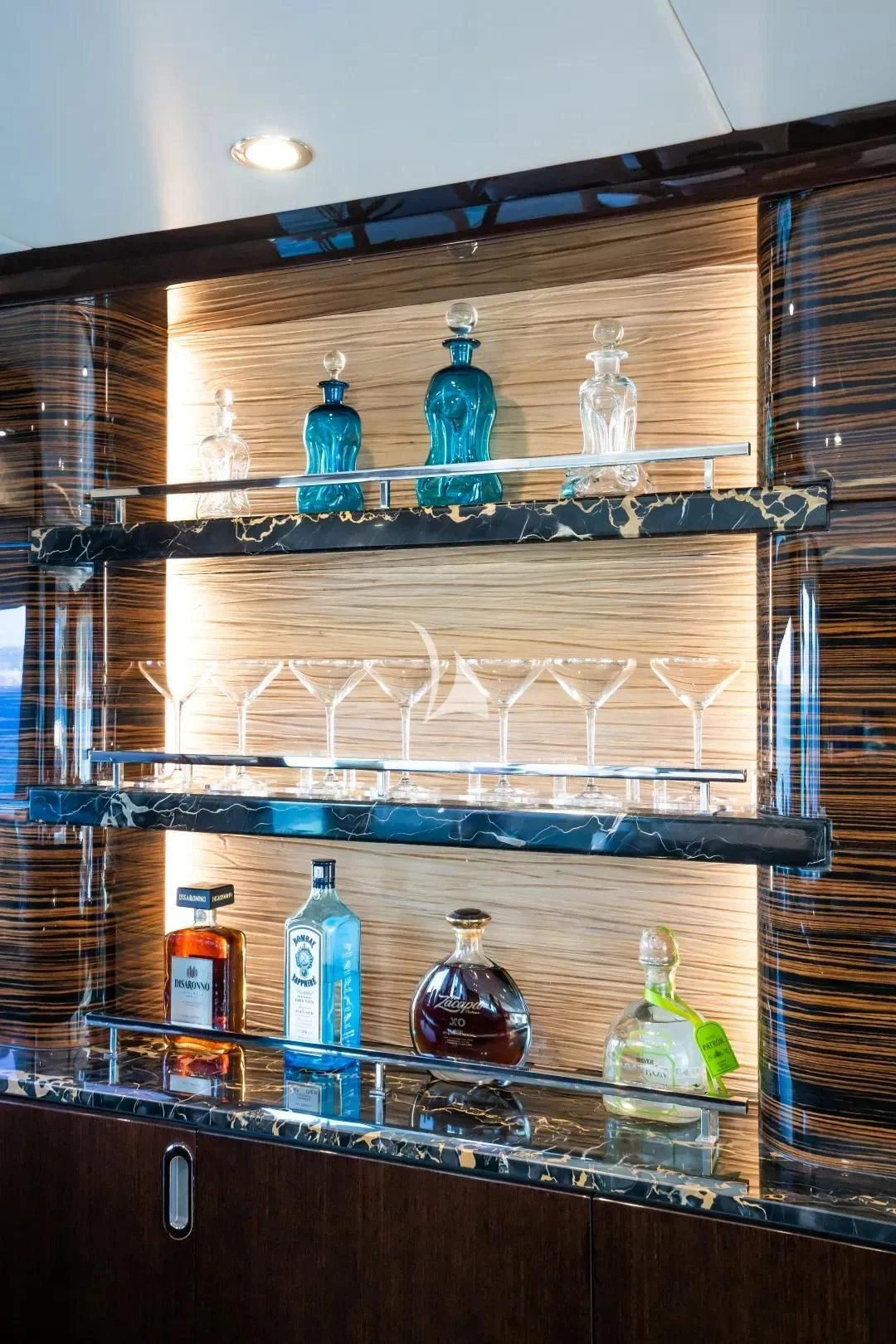 a shelf with glass bottles aboard NO.9 Yacht for Sale
