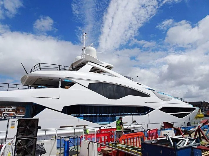 a large white boat with a person standing on it aboard NO.9 Yacht for Sale