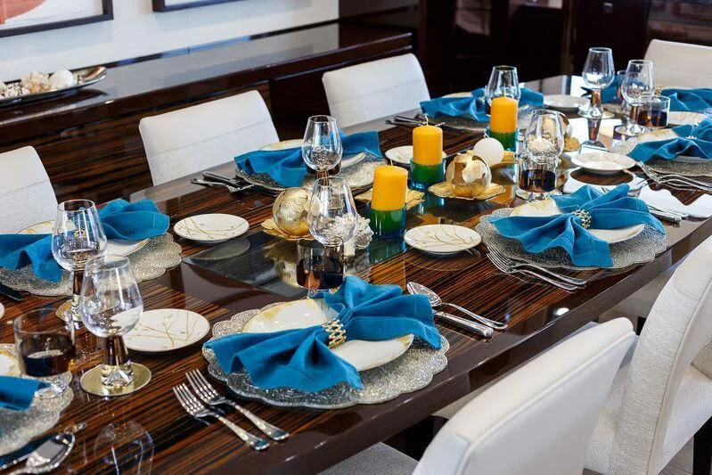 a table with plates and glasses aboard NO.9 Yacht for Sale