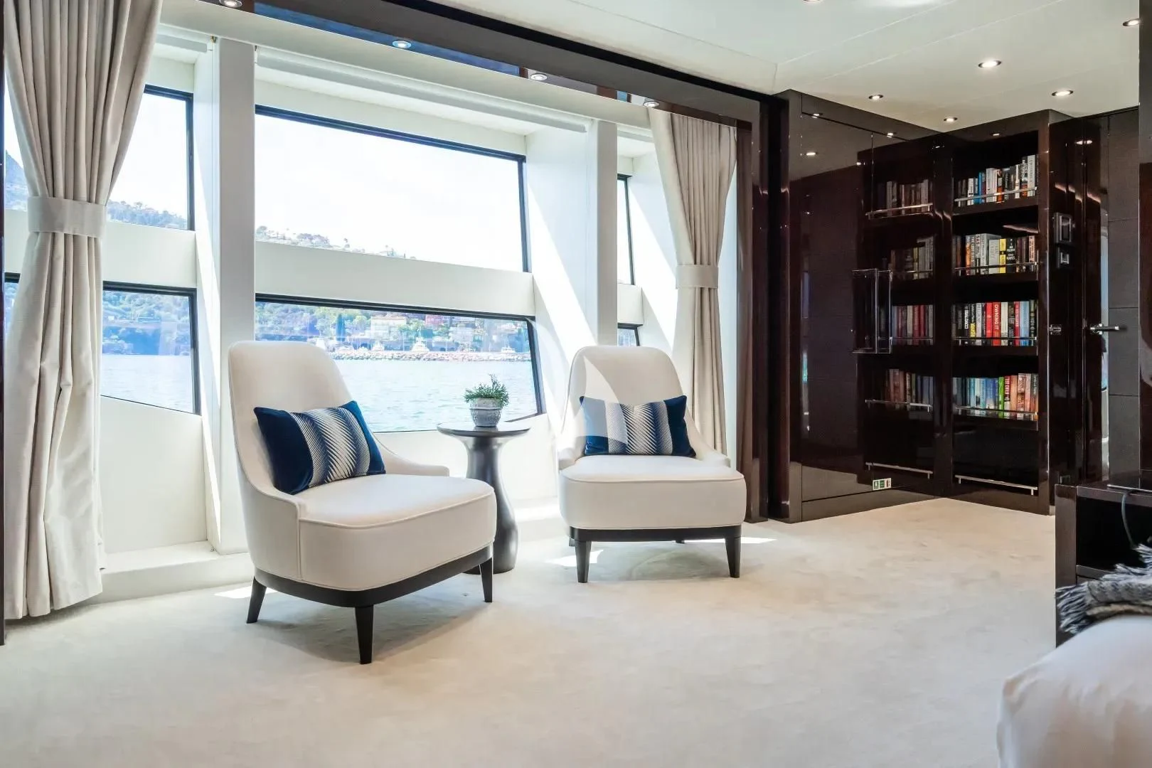 a room with a bookcase and a chair and a table aboard NO.9 Yacht for Sale