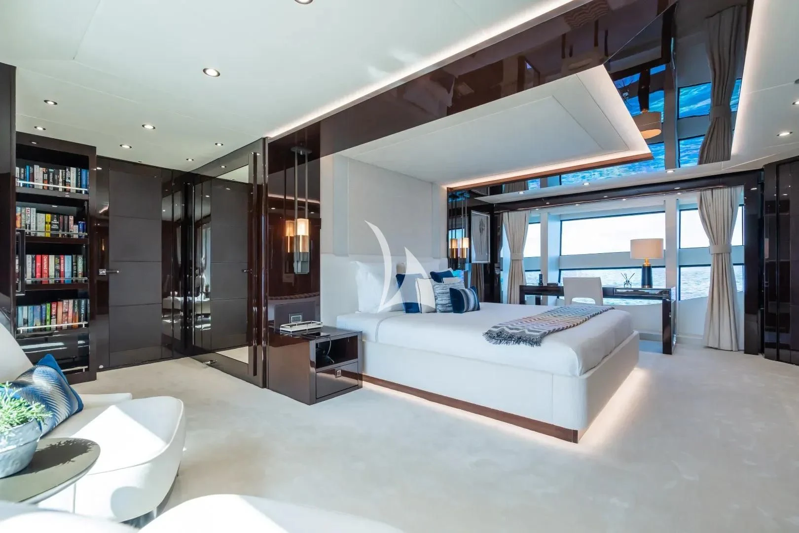 a room with a bed and a bookcase aboard NO.9 Yacht for Sale