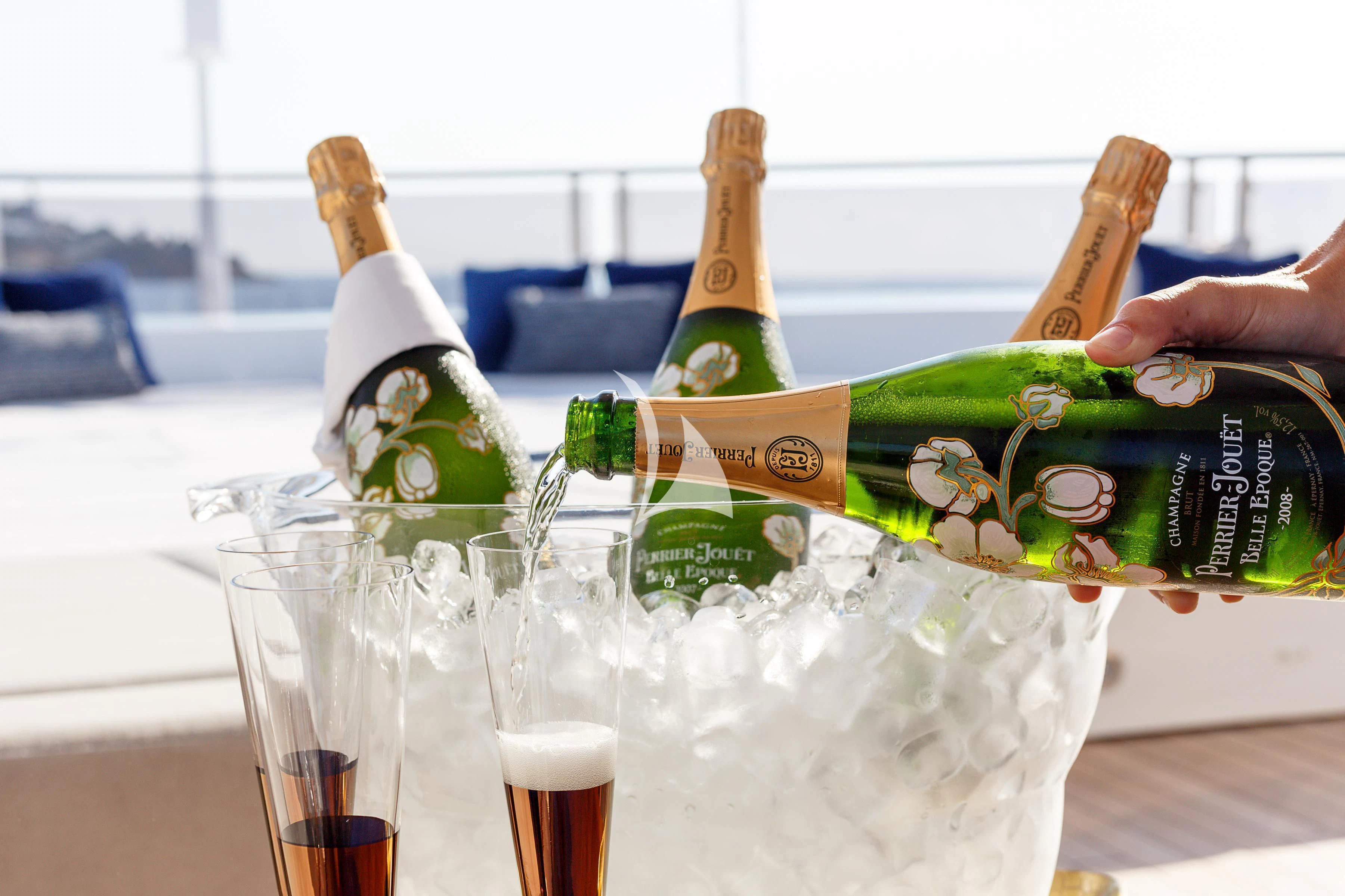 a bottle of champagne and glasses aboard NO.9 Yacht for Sale