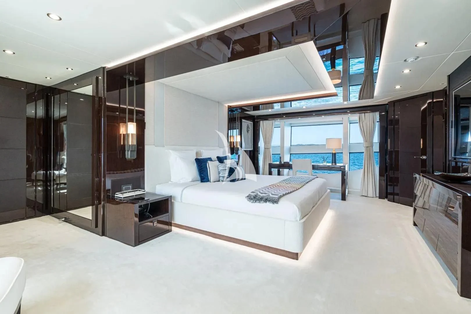 a large room with a bed and a desk aboard NO.9 Yacht for Sale