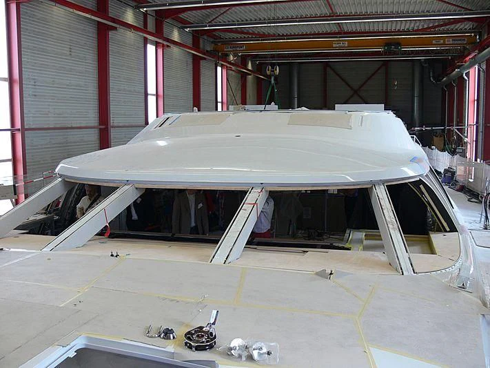 a large white boat in a warehouse aboard NIRVANA FORMENTERA Yacht for Sale