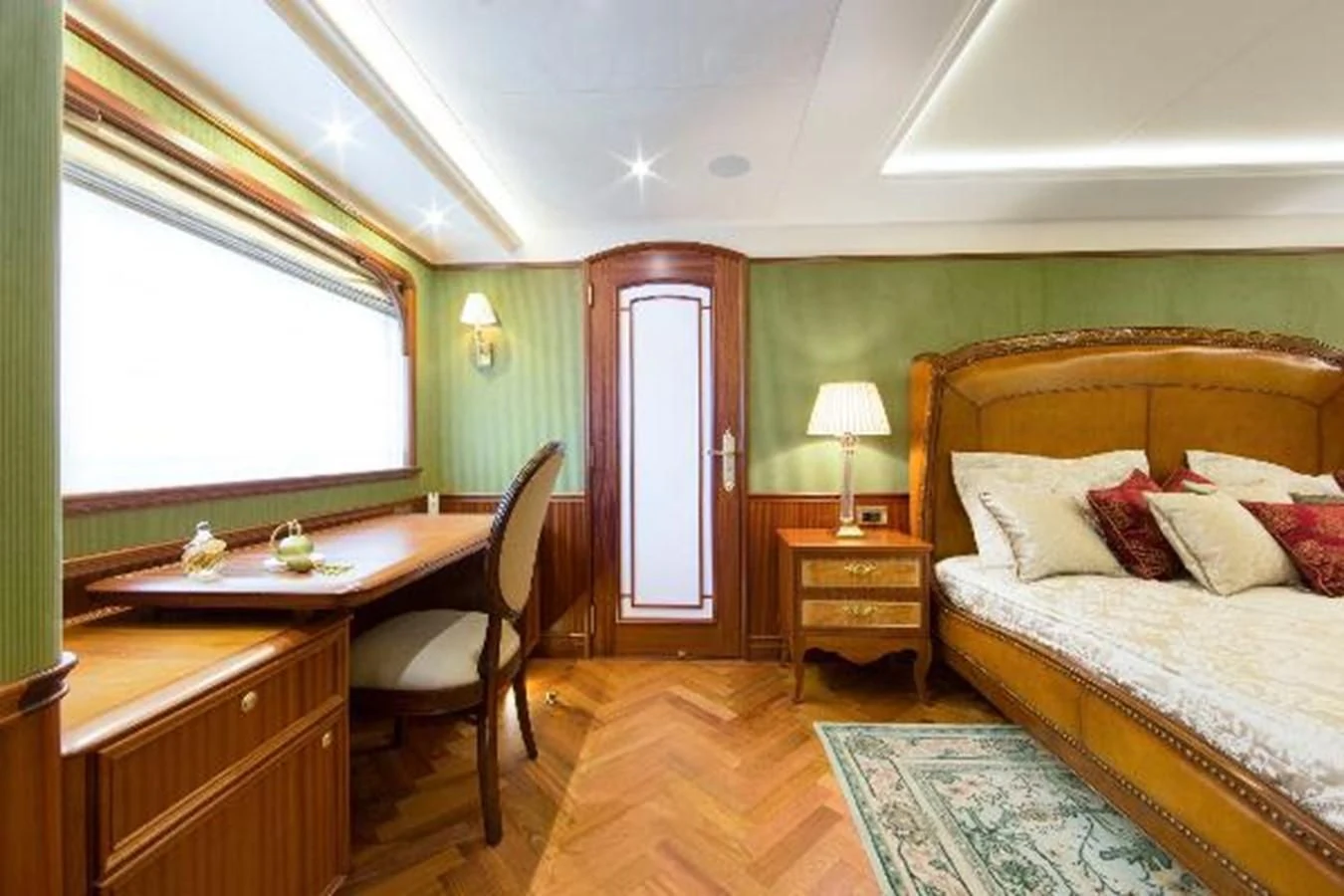 a bedroom with a bed and desk aboard 121FT EXPLORER 37 Yacht for Sale