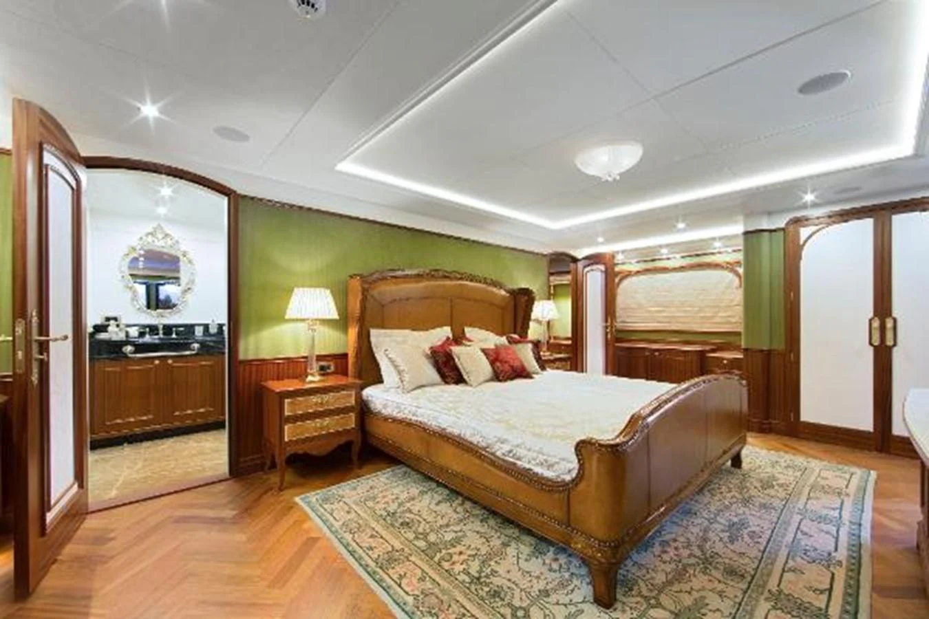 a bedroom with a bed and a mirror aboard 121FT EXPLORER 37 Yacht for Sale