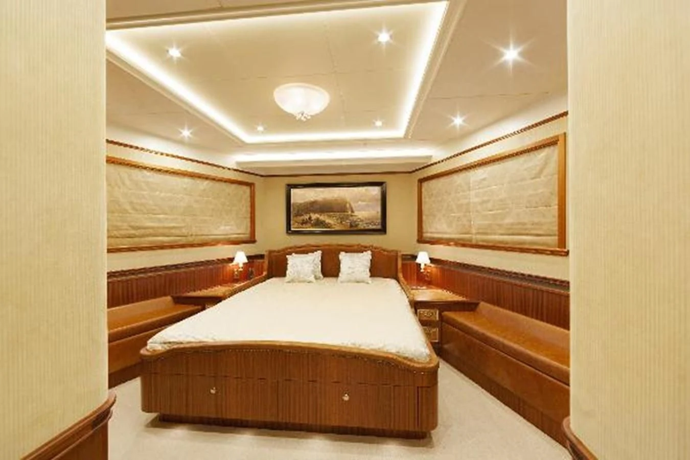 a room with a bed and a painting on the wall aboard 121FT EXPLORER 37 Yacht for Sale