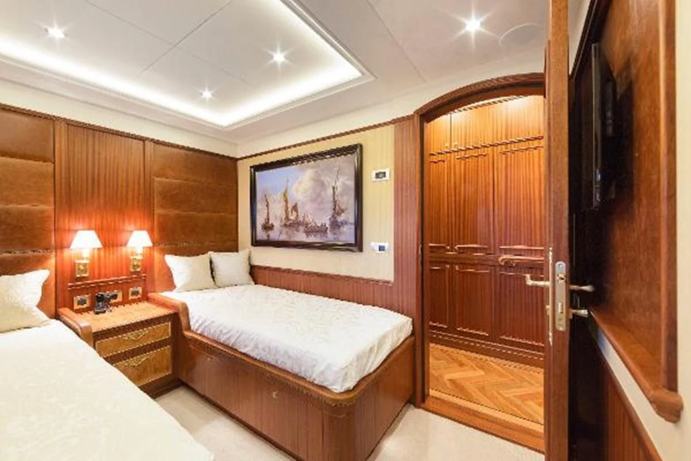 a bedroom with a bed and a wood door aboard 121FT EXPLORER 37 Yacht for Sale