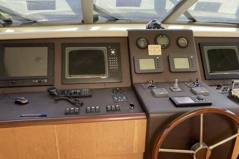 a control panel with a monitor and other electronic devices aboard NIKE III Yacht for Sale