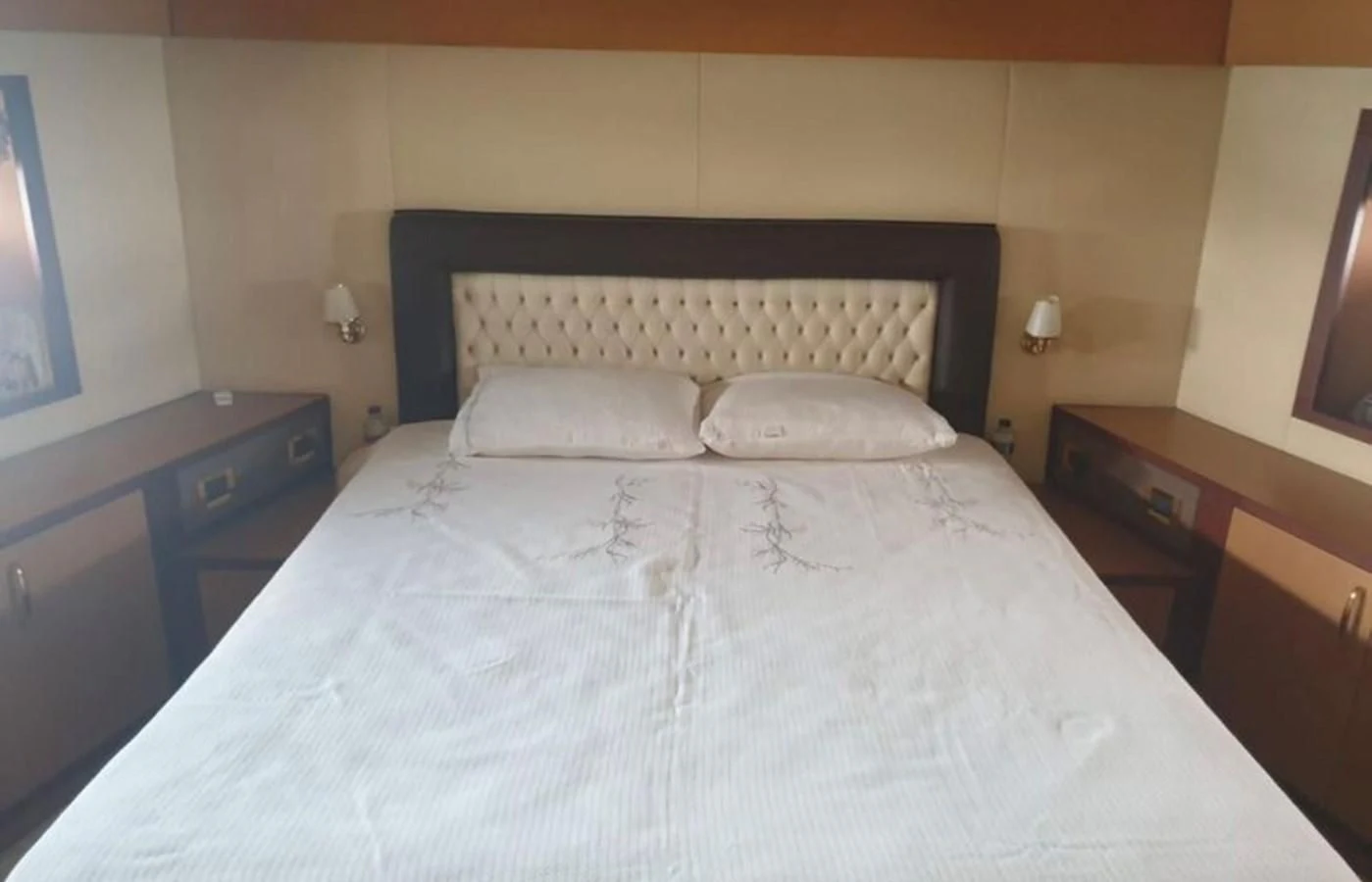 a bed with white sheets aboard NIKE III Yacht for Sale