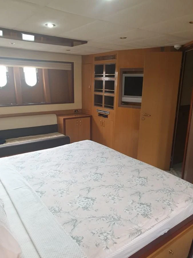 a bedroom with a large bed aboard NIKE III Yacht for Sale