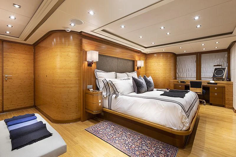 a room with a bed and a desk aboard LUMIR Yacht for Sale