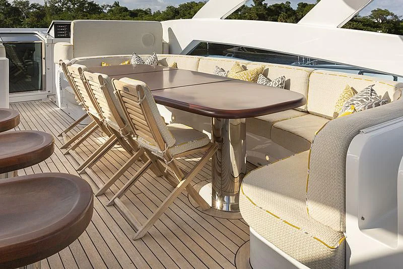 a table and chairs on a deck aboard LUMIR Yacht for Sale
