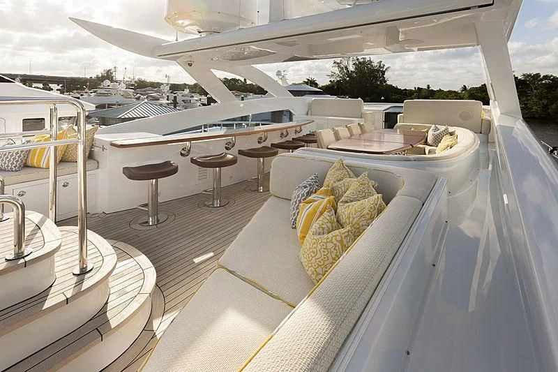 a deck with a table and chairs aboard LUMIR Yacht for Sale