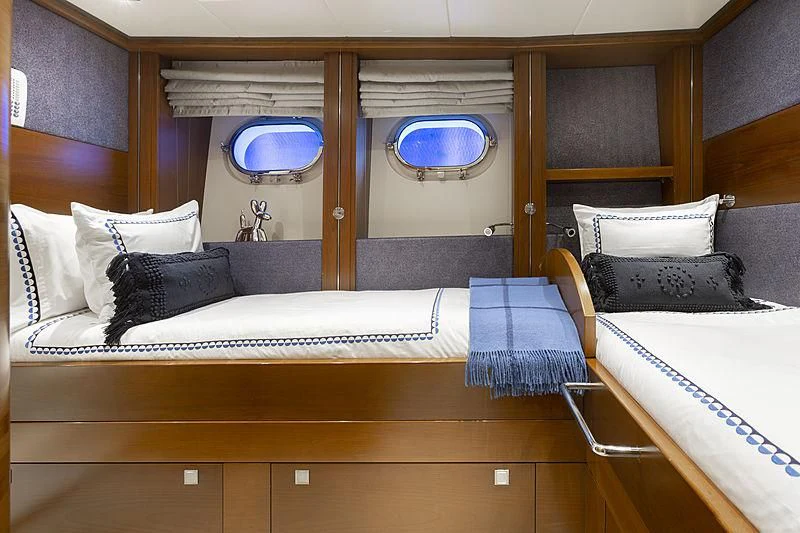 a room with a bed and a mirror aboard LUMIR Yacht for Sale