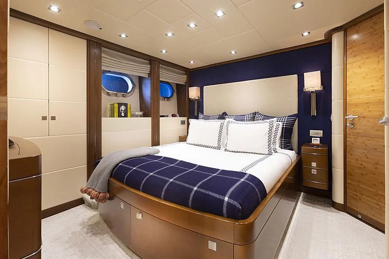 a bedroom with a bed aboard LUMIR Yacht for Sale
