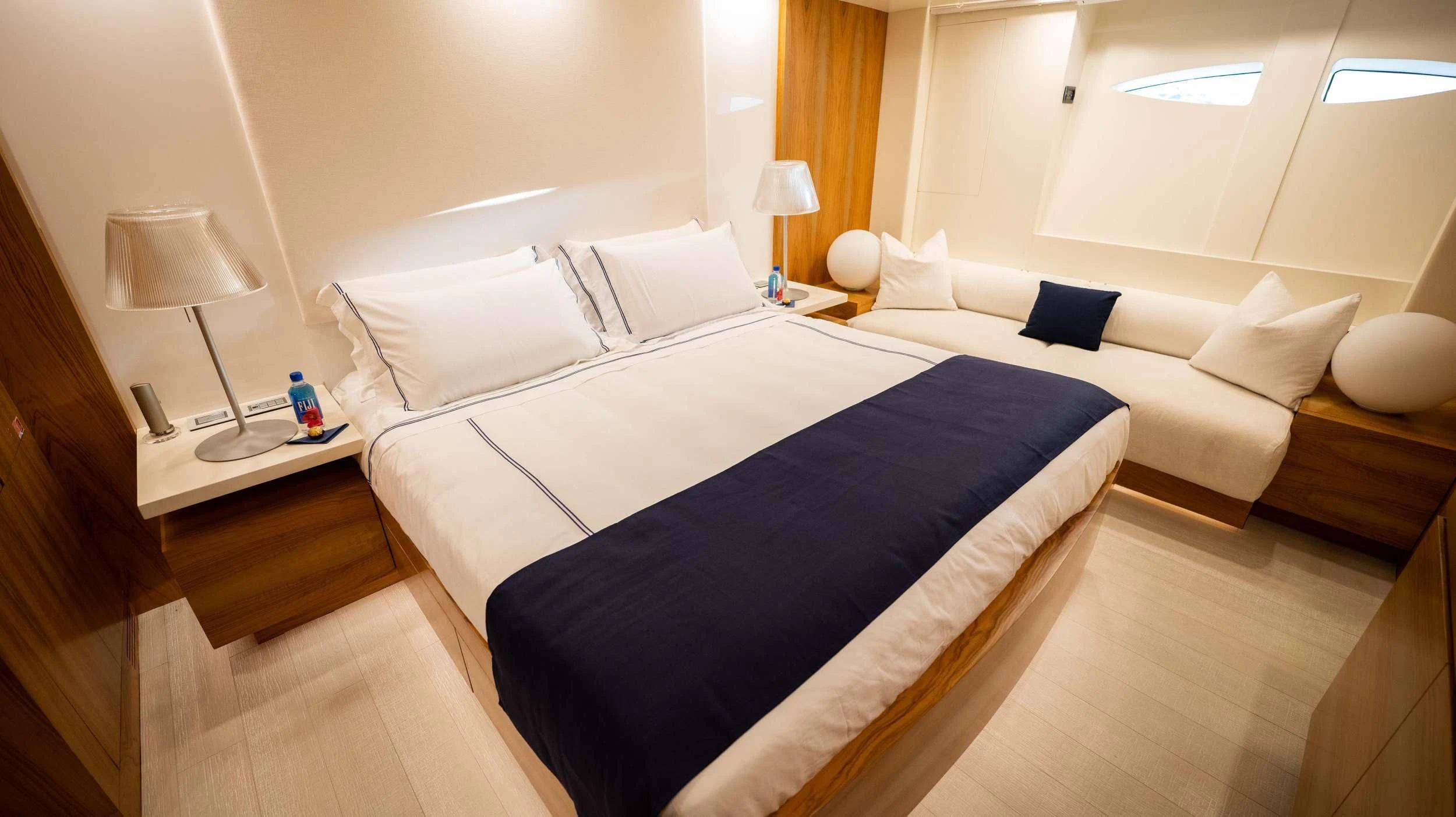 a room with a bed and a lamp aboard BLUE DEVIL Yacht for Sale