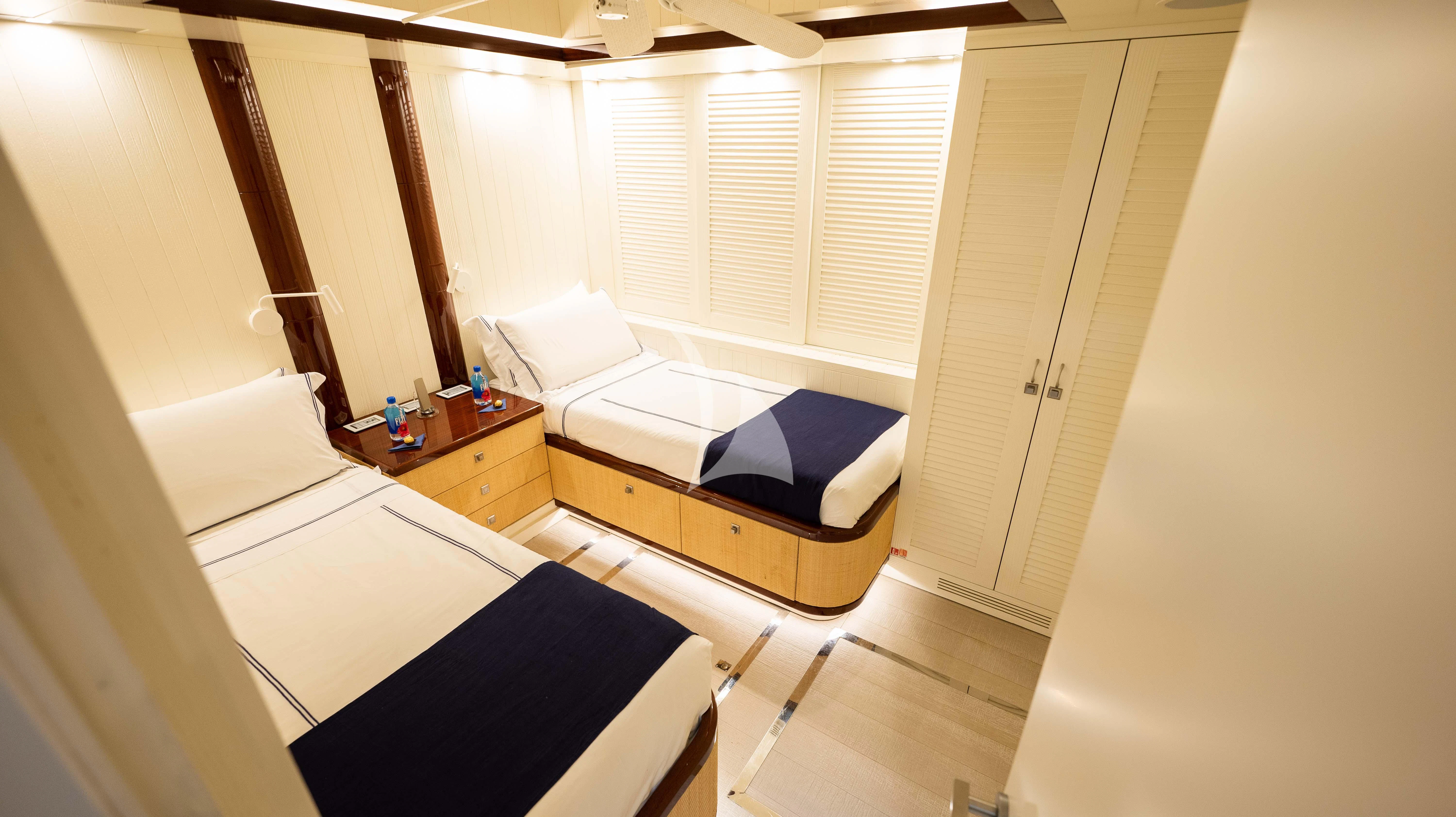 a room with a bed and a desk aboard BLUE DEVIL Yacht for Sale