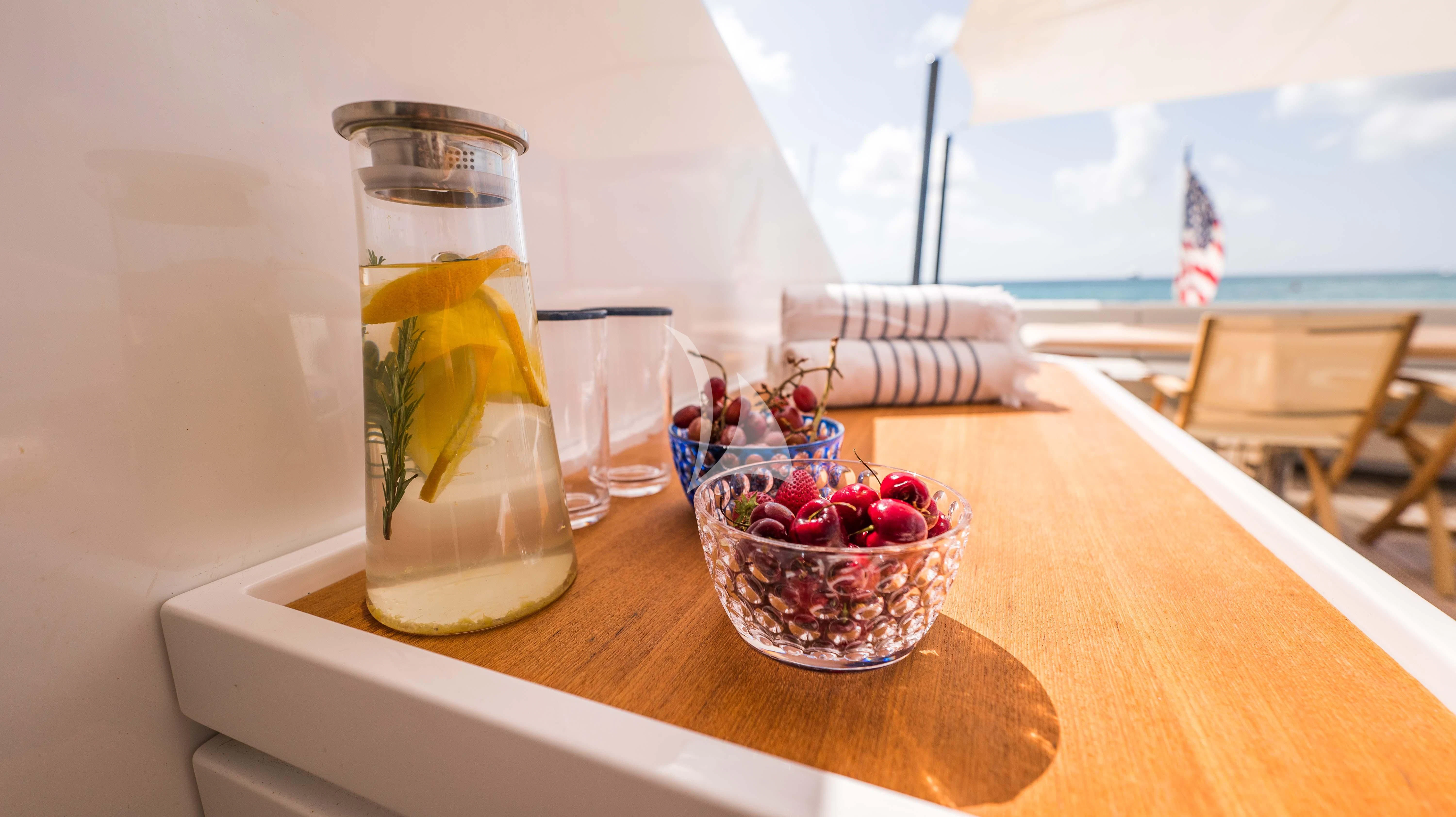 a glass of liquid and a glass on a table aboard BLUE DEVIL Yacht for Sale