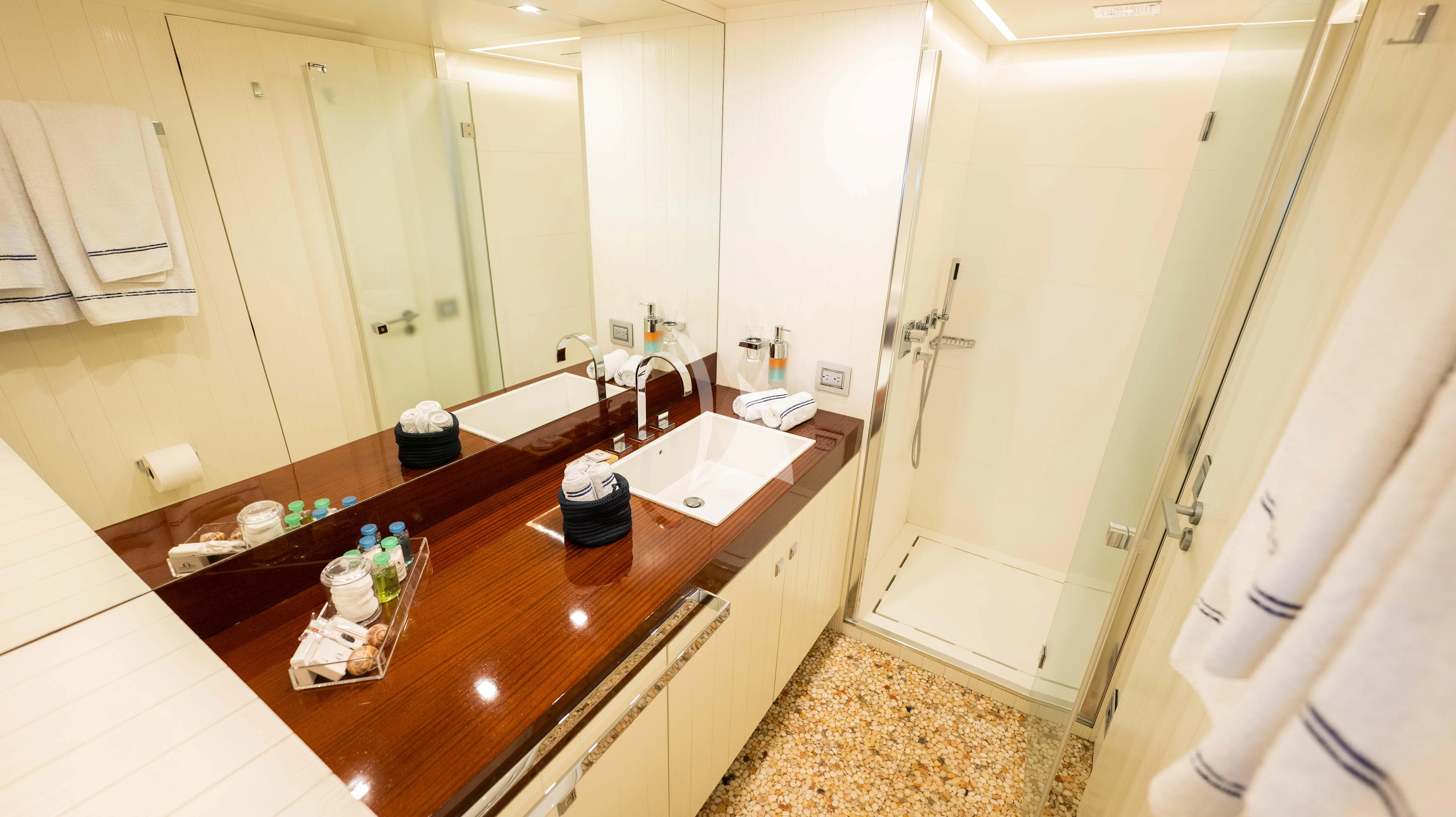 a bathroom with a countertop sink and a shower aboard BLUE DEVIL Yacht for Sale