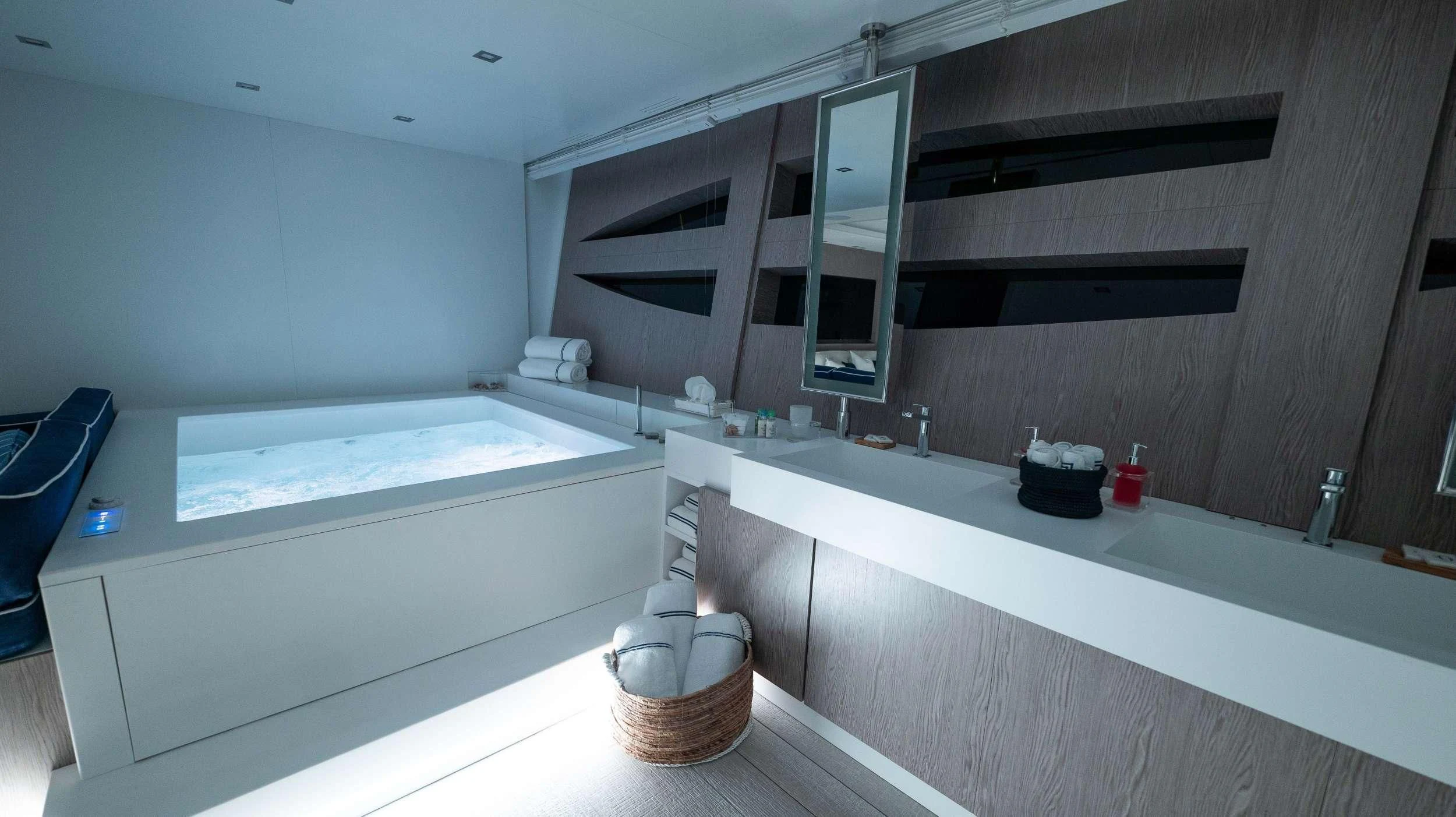 a bathroom with a tub and a sink aboard BLUE DEVIL Yacht for Sale