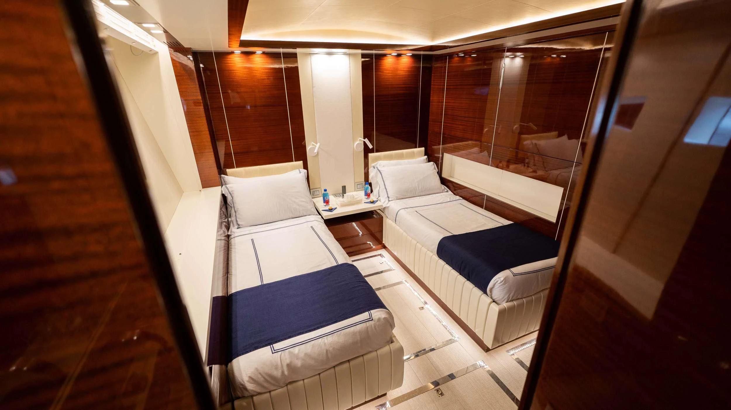 a room with a bed and a table aboard BLUE DEVIL Yacht for Sale