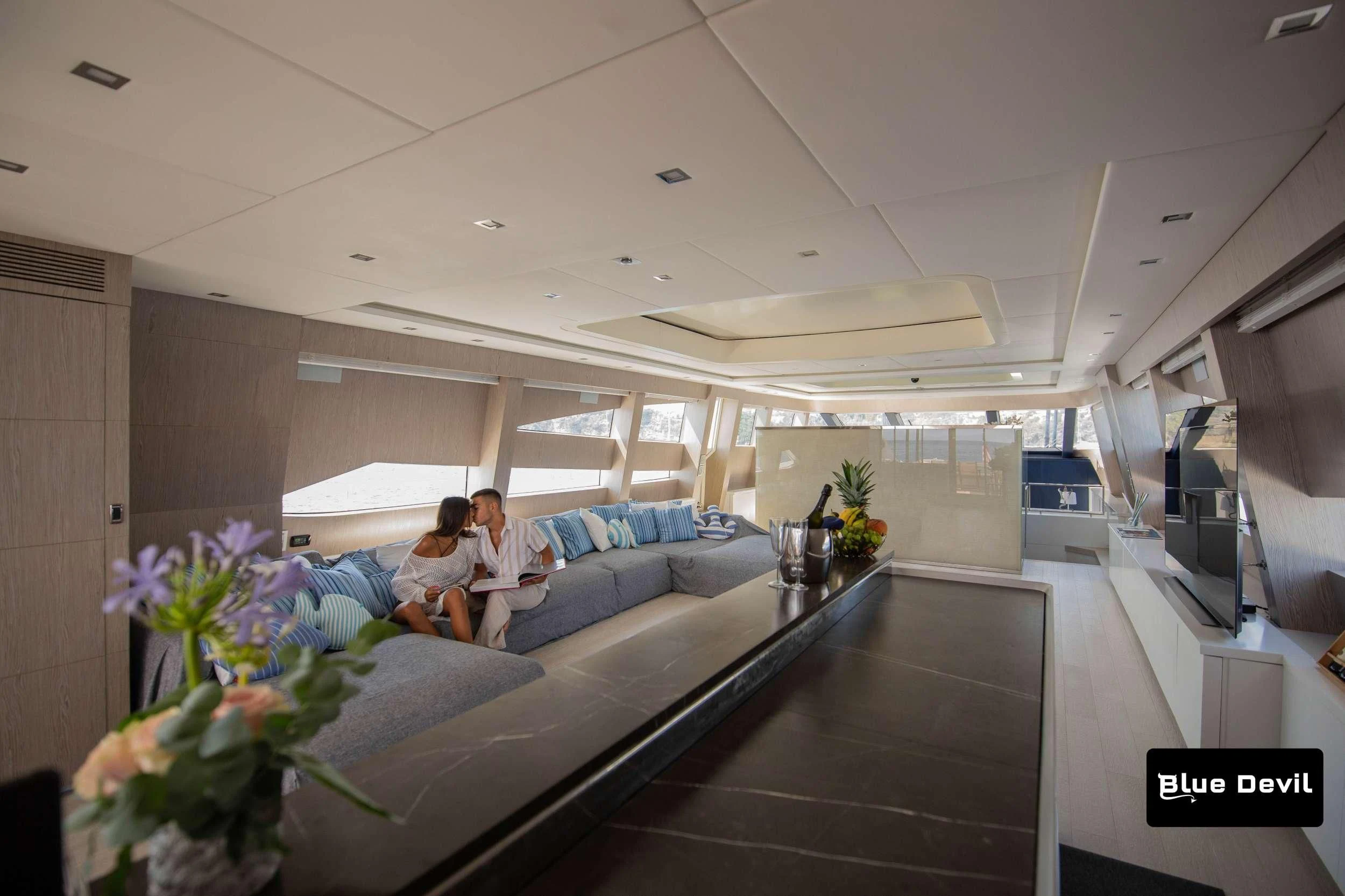 a couple sitting on a couch aboard BLUE DEVIL Yacht for Sale
