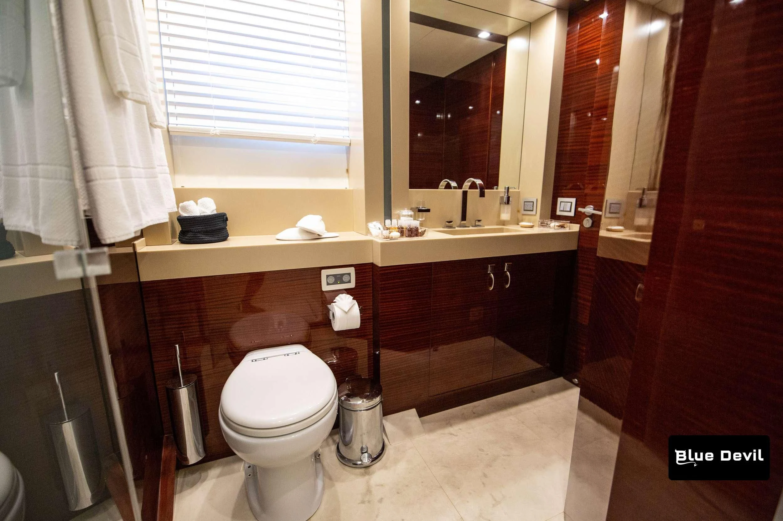 a bathroom with a toilet sink and a mirror aboard BLUE DEVIL Yacht for Sale