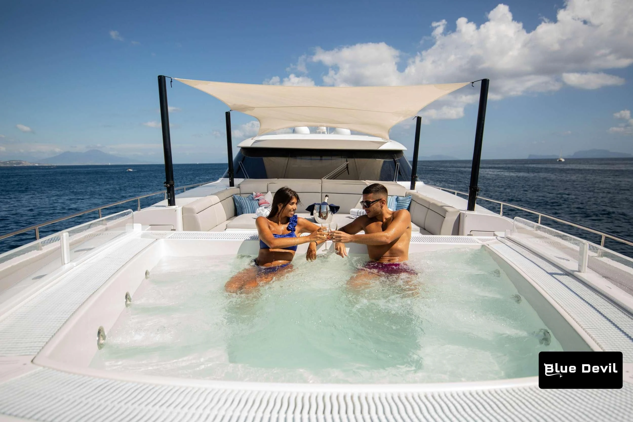 a man and woman sitting in a pool on a boat aboard BLUE DEVIL Yacht for Sale